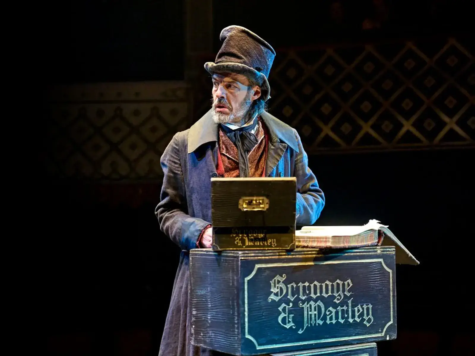 Scrooge at his counting house, the Scrooge and Marley ledger before him
