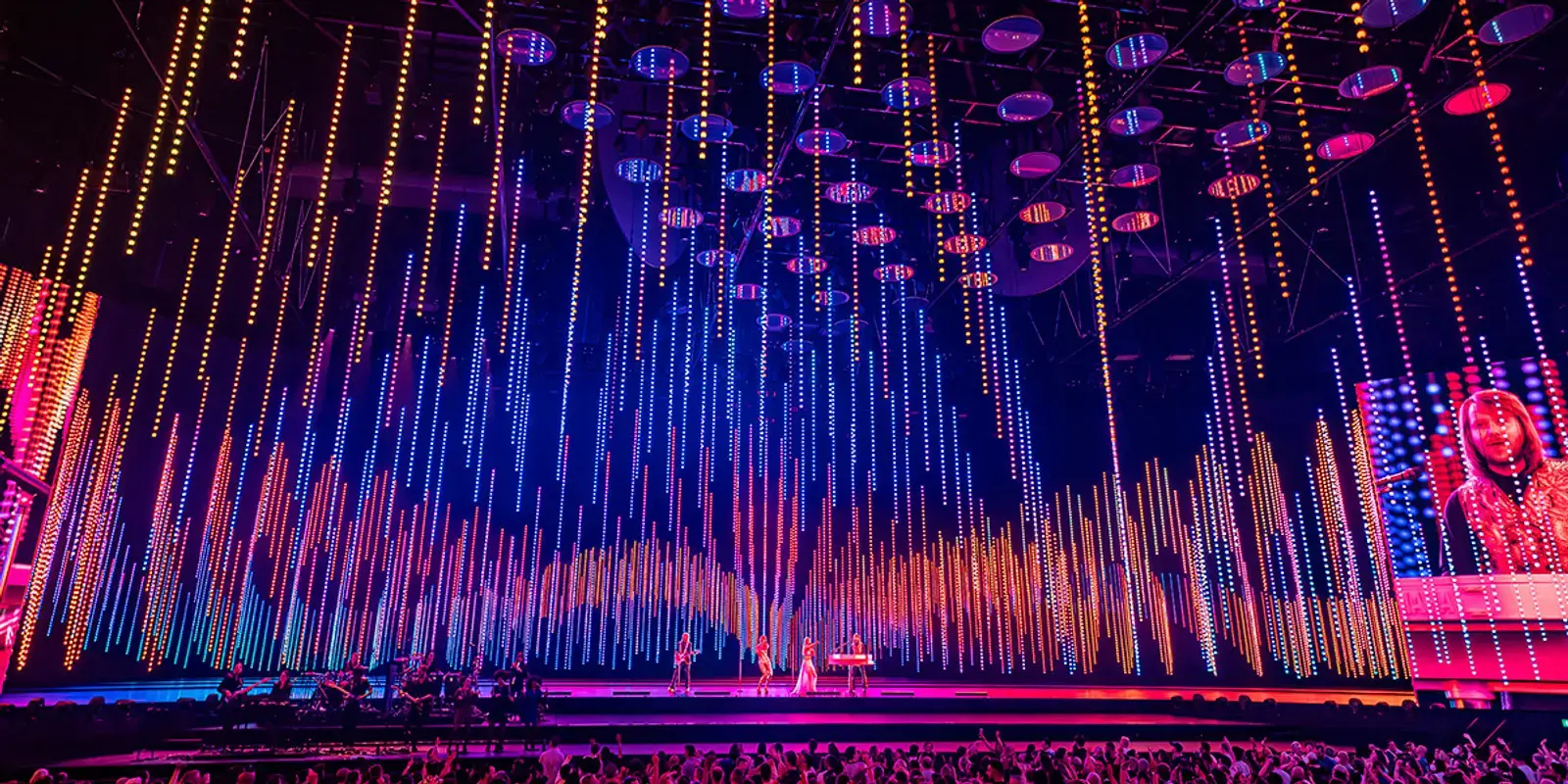 A wide arena view under a cascade of coloured LED light