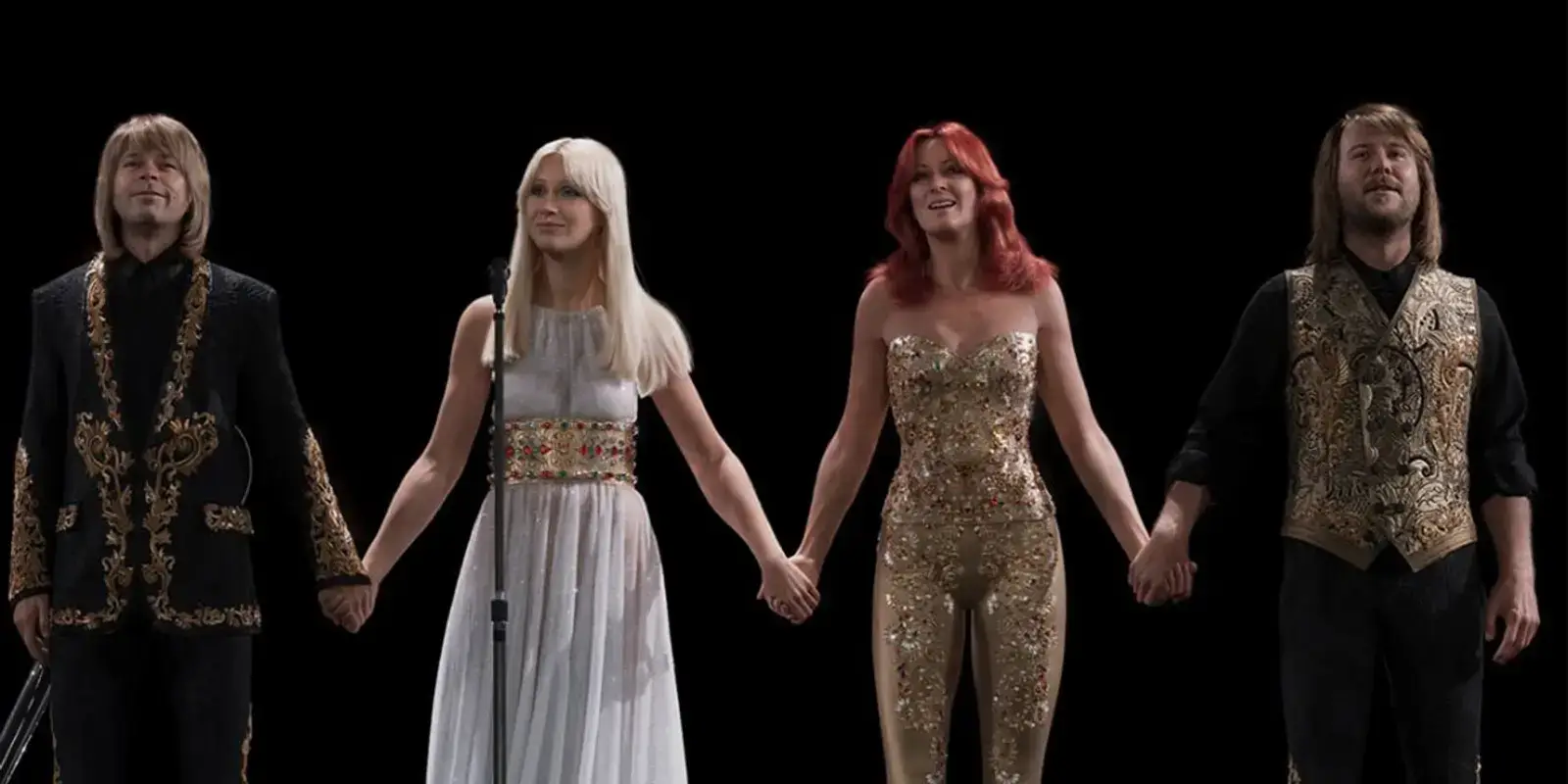 The four ABBAtars hold hands at the curtain call