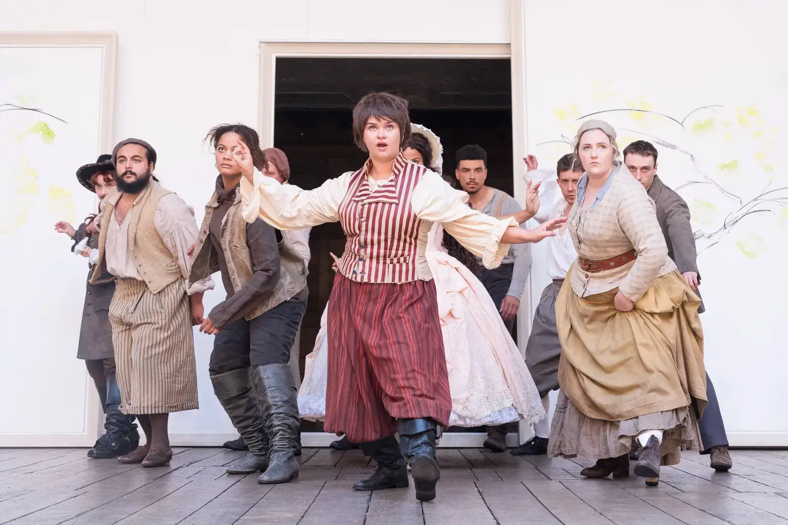 The ensemble mid-dance in the Forest of Arden