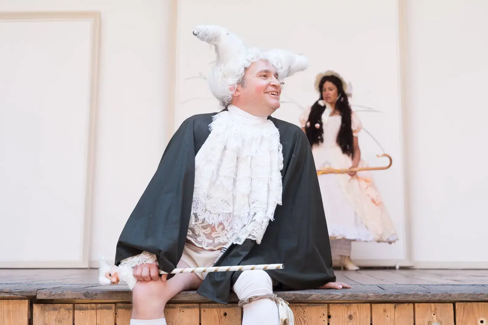 A courtier in a towering white wig with a shepherdess behind