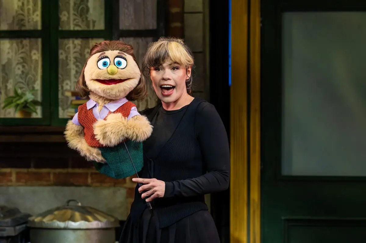 Emily Benjamin performing with the Kate Monster puppet in Avenue Q at the Shaftesbury Theatre, London