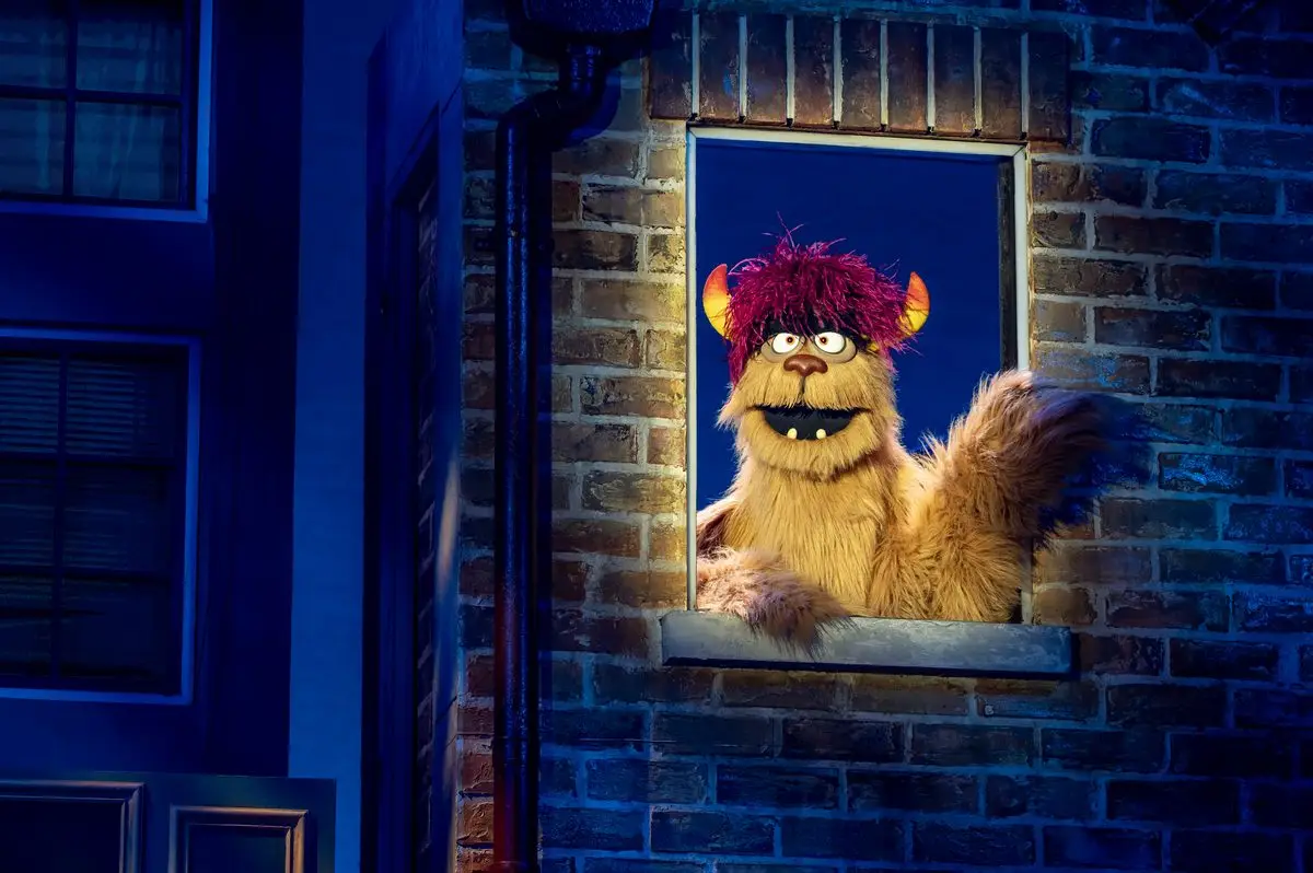 Trekkie Monster leaning out of his apartment window in Avenue Q at the Shaftesbury Theatre, London