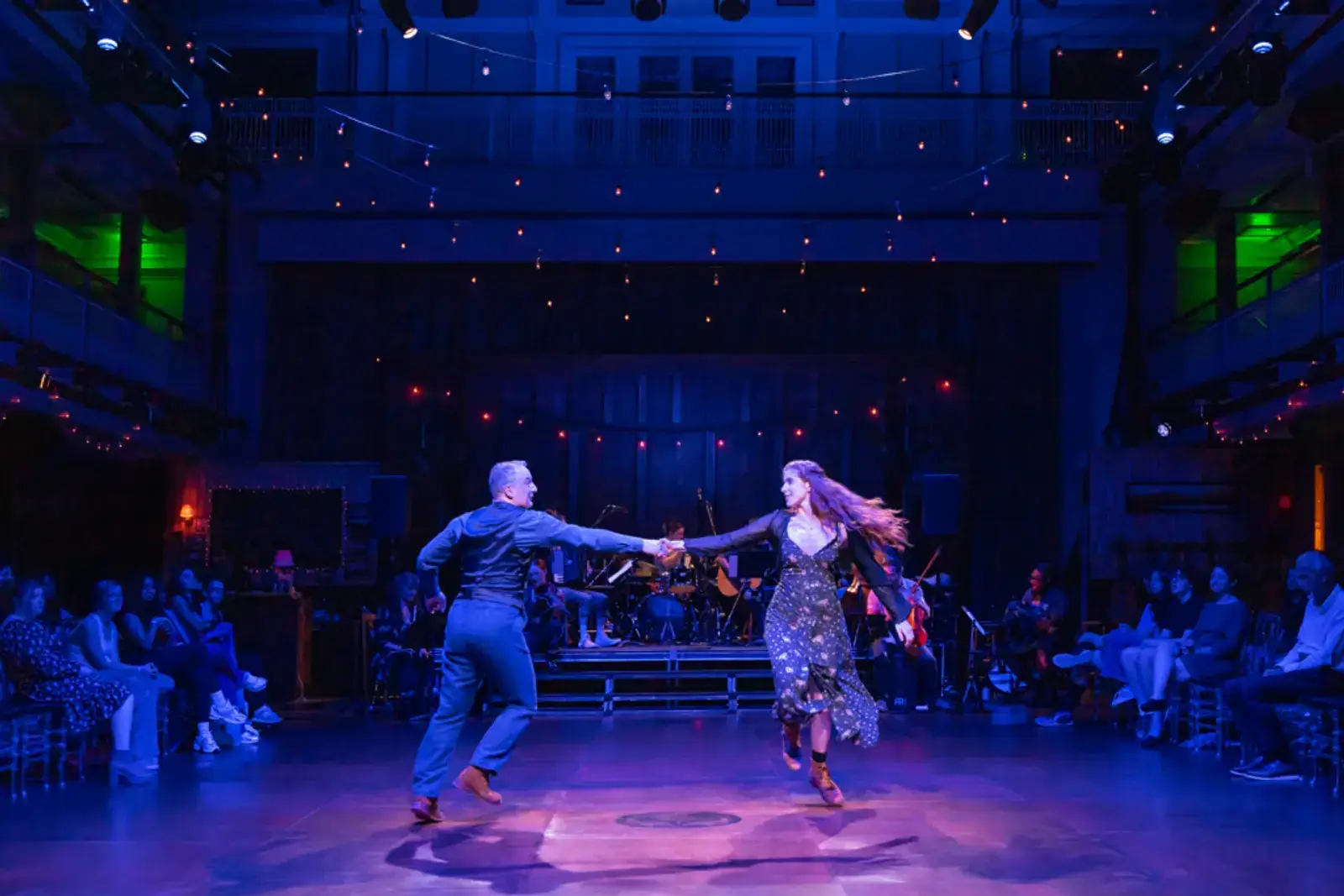 A blue-lit partnered dance