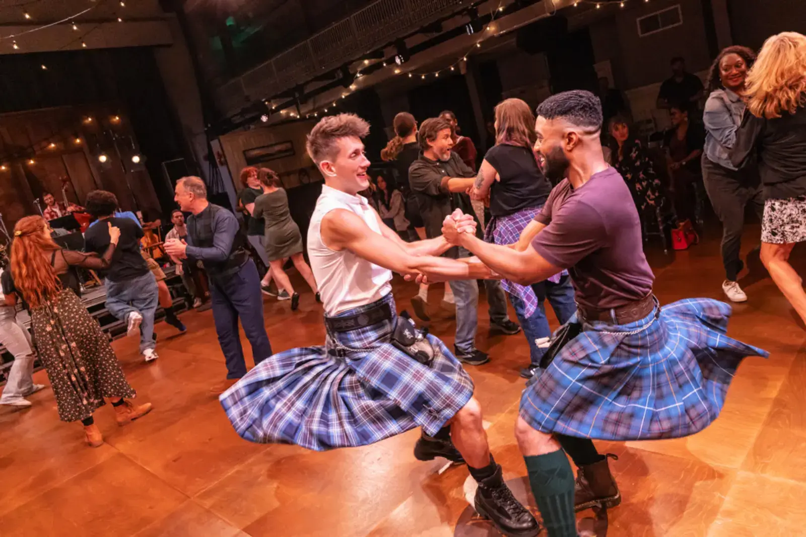 Two dancers in kilts spinning