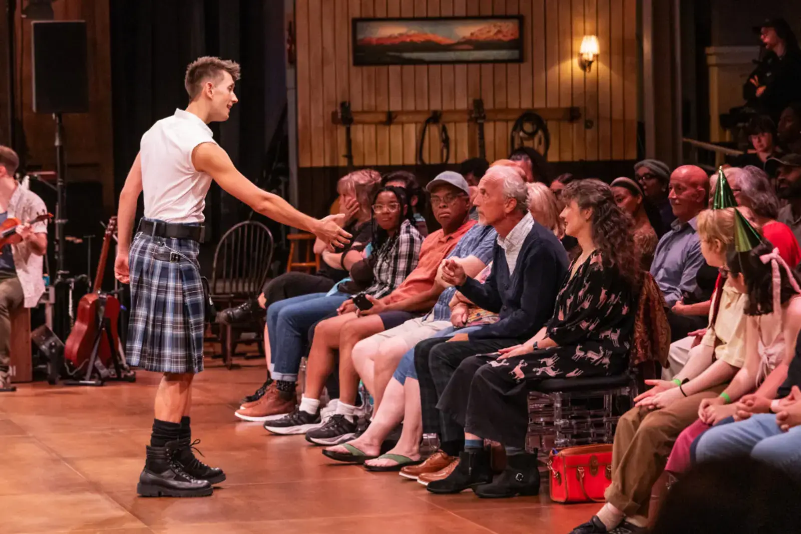 The caller reaches out to bring the audience up to dance