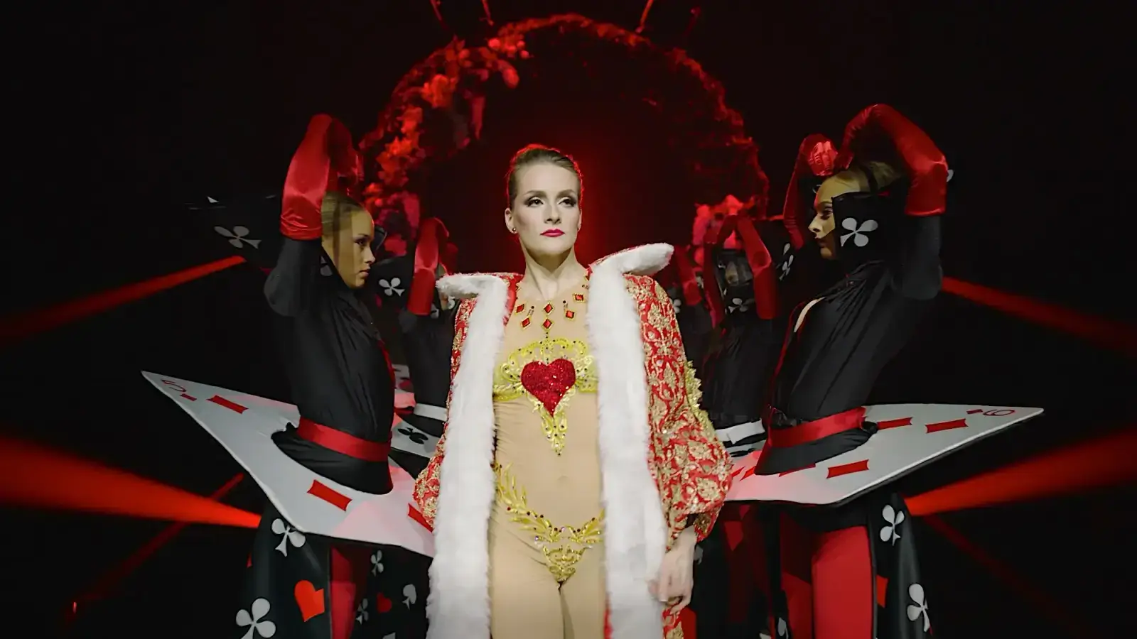 The Queen of Hearts flanked by playing-card acrobats