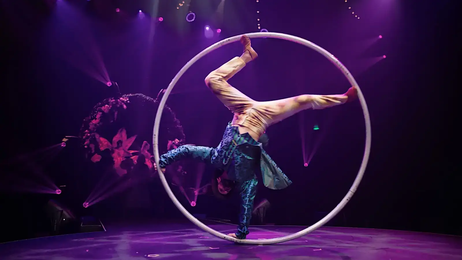 A Cyr wheel performer mid-spin