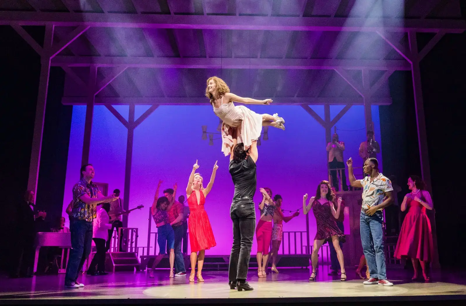 Johnny lifts Baby in the show's iconic climactic lift as the company cheers