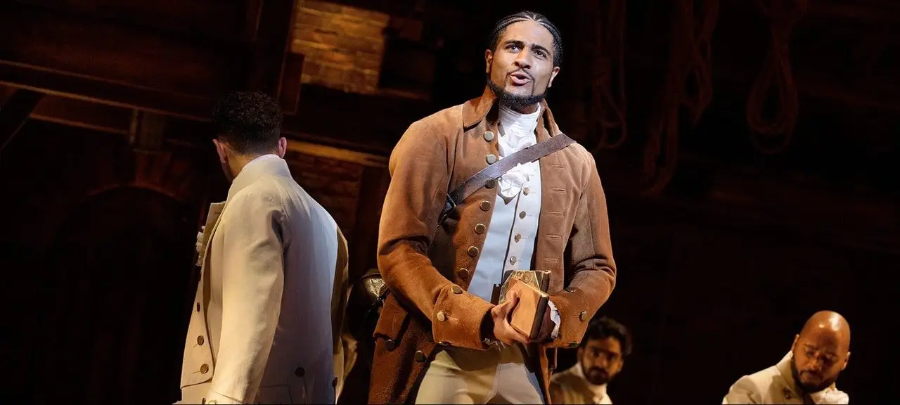 The full company of Hamilton on stage at the Victoria Palace Theatre, London