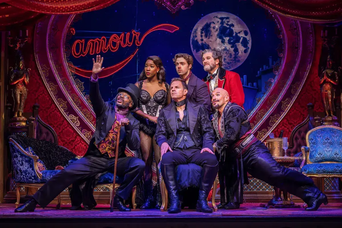 The principal cast beneath the amour sign