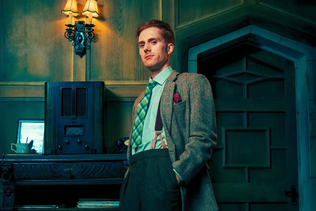 Christopher Wren standing by the fireplace in The Mousetrap at St Martin's Theatre, London