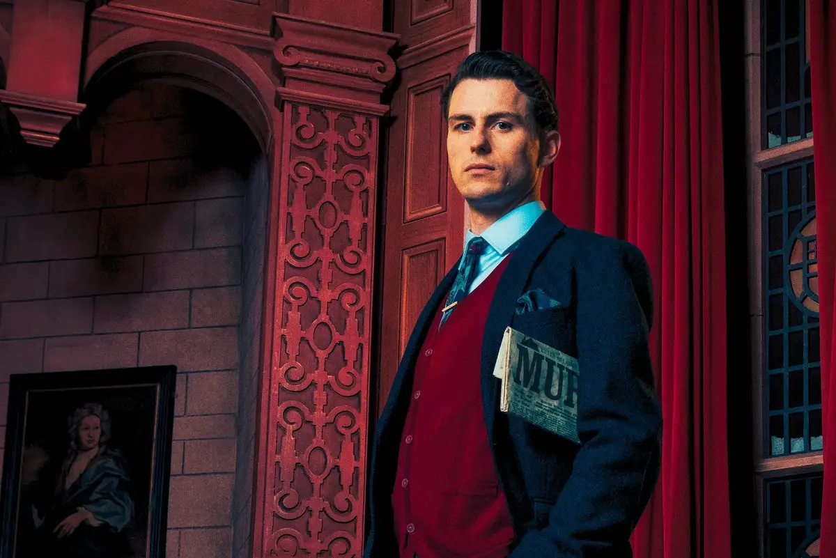 Giles Ralston holding a newspaper with the headline MURDER in The Mousetrap at St Martin's Theatre, London