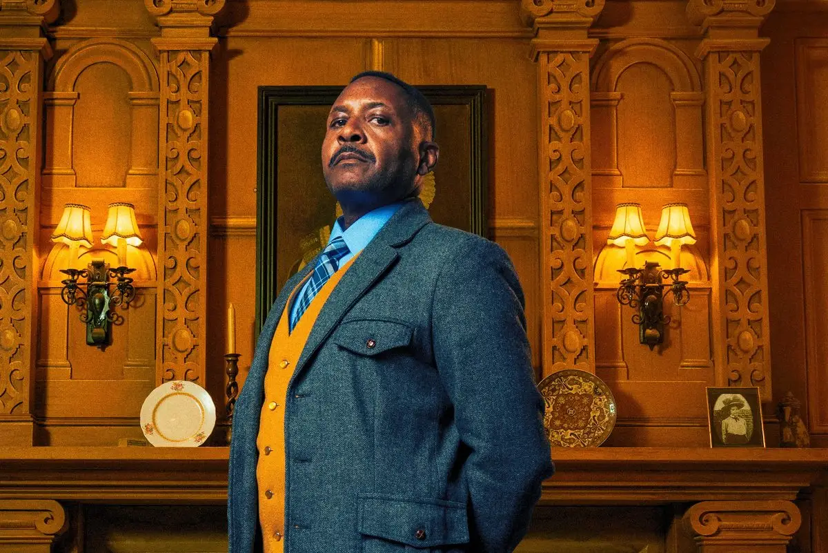 Major Metcalf standing by the fireplace in The Mousetrap at St Martin's Theatre, London