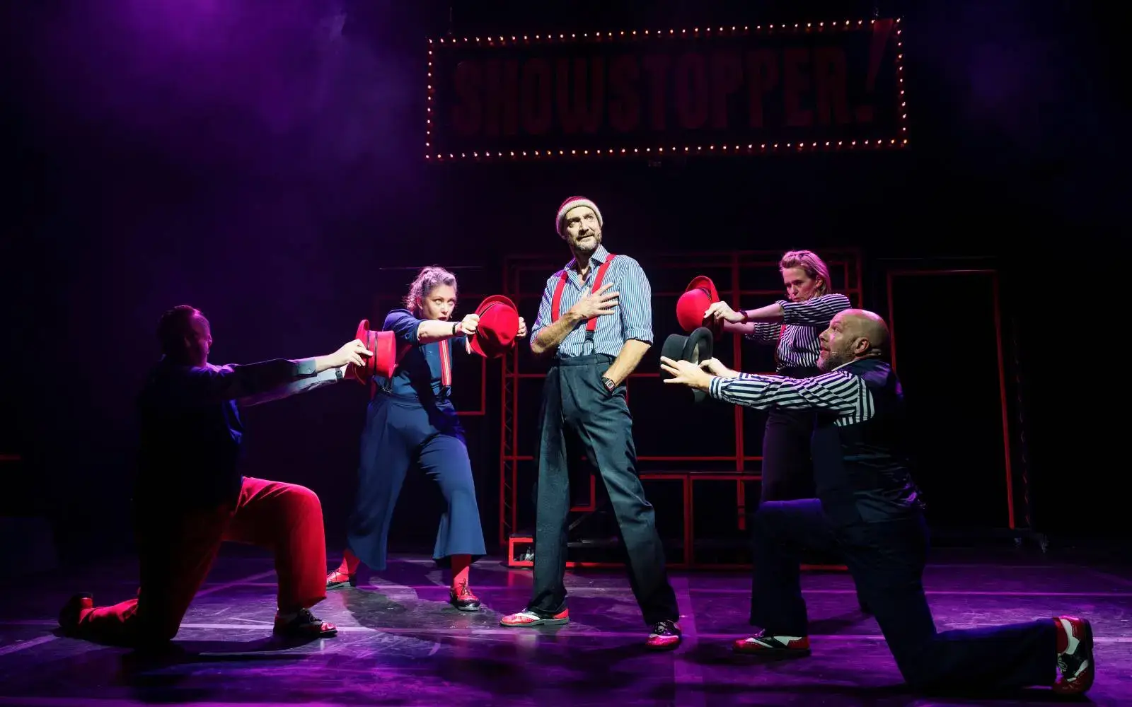 A hat-passing routine in purple light