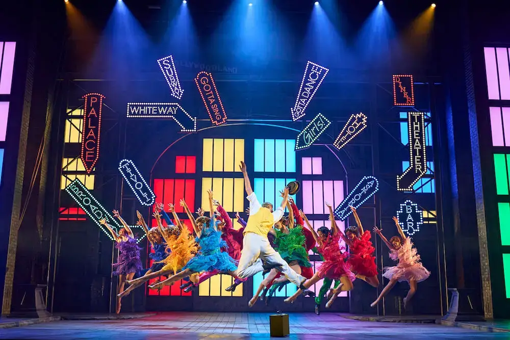 The company mid-leap in the Broadway Melody number