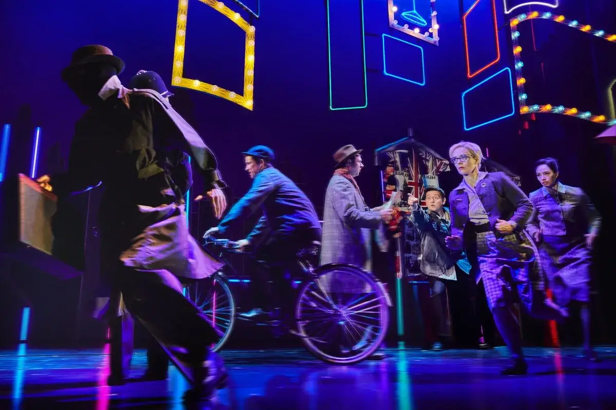 The company on a London street scene with a bicycle in The Comedy About Spies - photography by Matt Crockett & Mark Senior