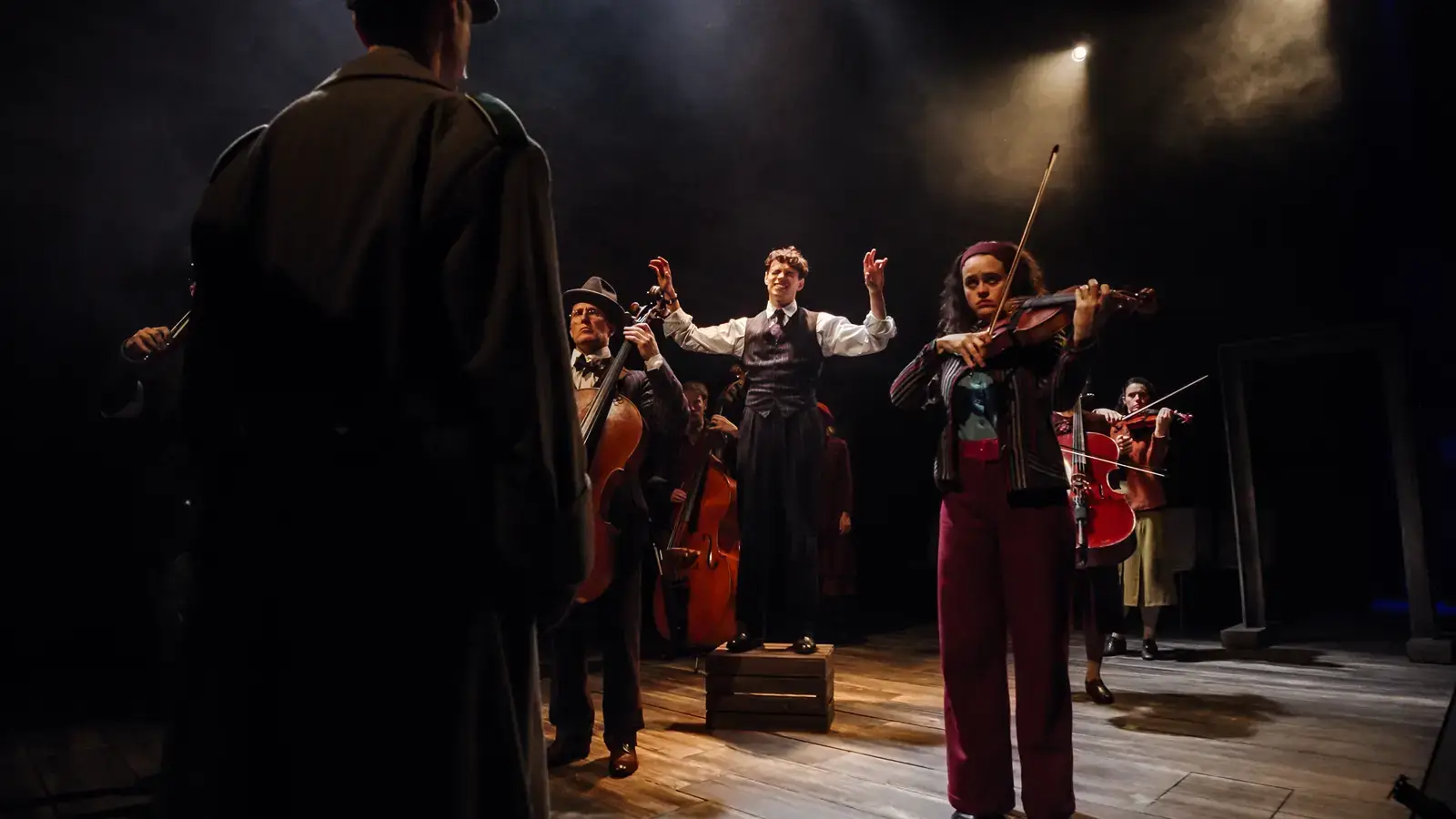 The company perform as an officer looks on