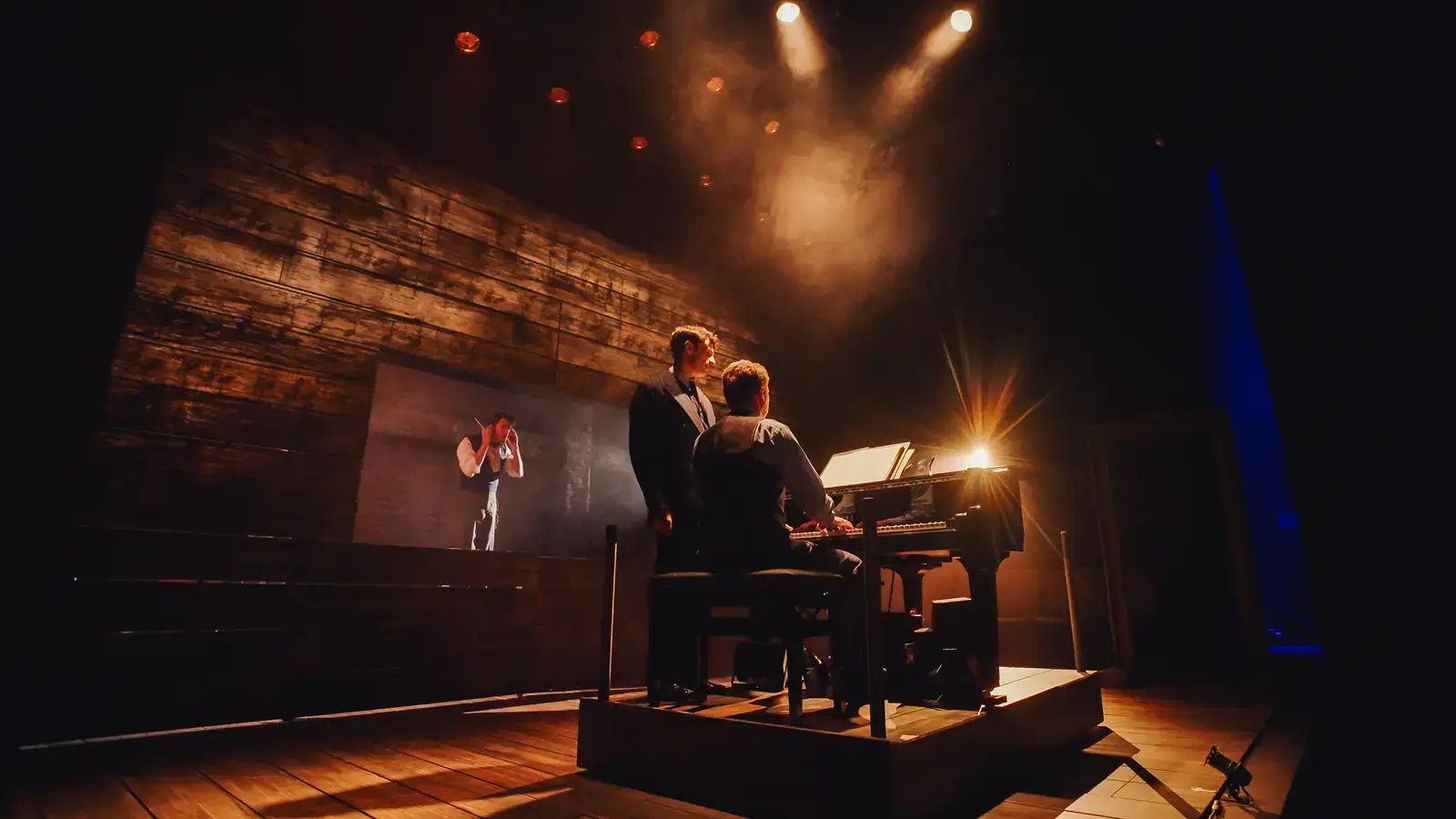 Szpilman at the piano with projection behind