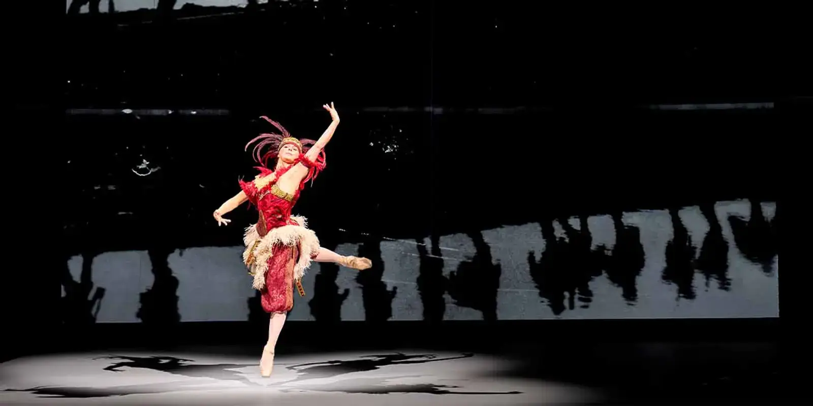 Natalia Osipova dancing en pointe in a red costume