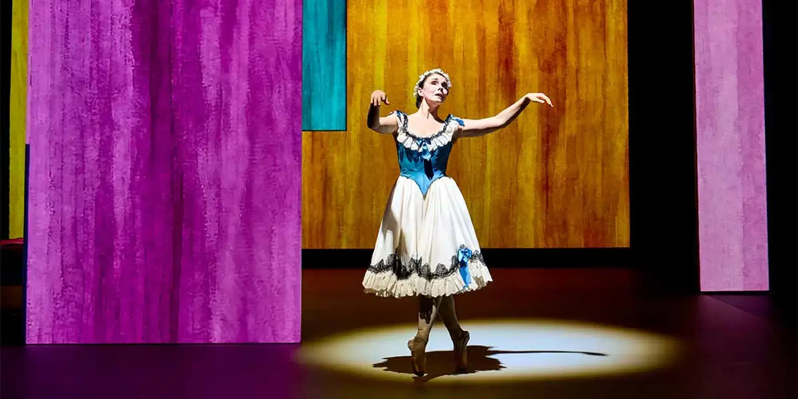 Natalia Osipova mid-dance in a blue and white tutu